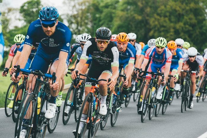 Cyclists racing together on an outdoor road